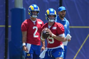 Jun 2, 2026; Woodland Hills, CA, USA; Los Angeles Rams quarterback Ty Simpson (15) throws the ball as quarterback Matthew Caldwell (2) and quarterbacks coach Dave Ragone watch during organized team activities at Rams Practice Facility. Mandatory Cred
