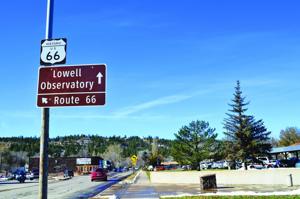 Signs for the Lowell Observatory and Route 66.