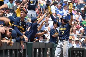 Jun 16, 2026; Omaha, NE, USA; West Virginia Mountaineers second baseman Gavin Kelly (2) reacts with teammate after scoring against the Troy Trojans during the second inning at Charles Schwab Field. Mandatory Credit: Steven Branscombe-Imagn Images