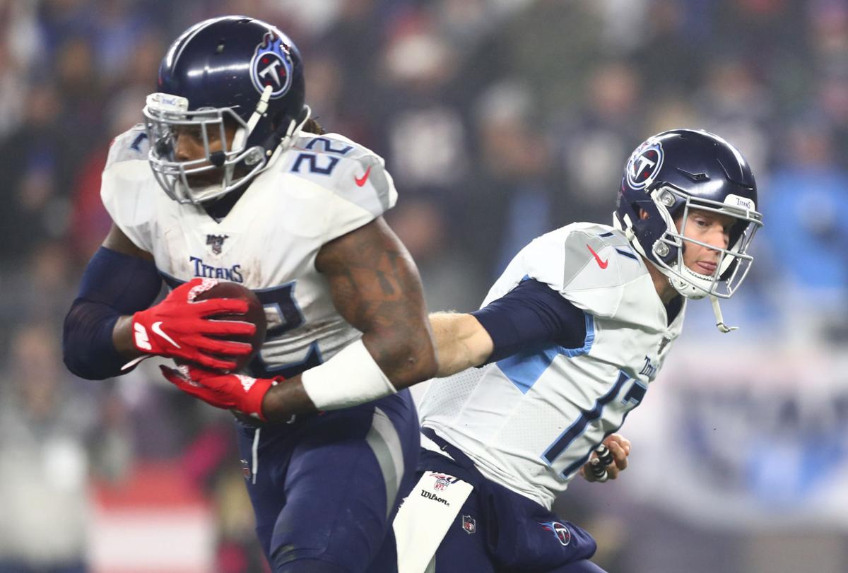 Ryan Tannehill #17 of the Tennessee Titans hands off to Derrick Henry #22 during the second half against the New England Patriots in the AFC Wild Card Playoff game at Gillette Stadium on January 04, 2020 in Foxborough, Massachusetts.