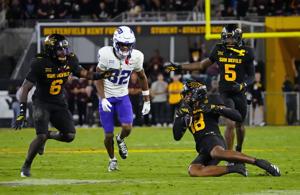 Arizona State linebacker Martell Hughes (18) comes up with an interception, sealing the win against TCU wide receiver Dozie Ezukanma (82) during a game at Mountain America Stadium in Tempe on Sept. 26, 2025.