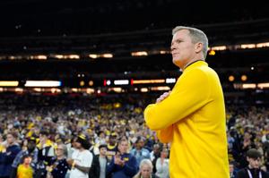 Michigan head coach Dusty May looks on from the court ahead of the NCAA national championship game against Connecticut at Lucas Oil Stadium in Indianapolis on Monday, April 6, 2026.
