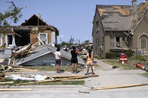 Residents inspect the damage amid debris and destroyed homes a day after a tornado ripped through Menasha, Wisconsin, on Tuesday, July 28, 2026.