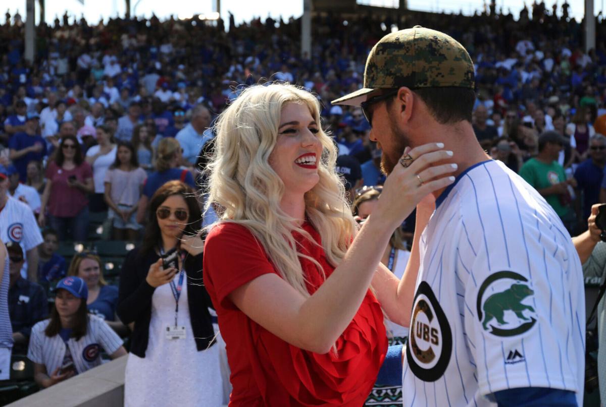 Julianna Zobrist greets her husband Ben Zobrist after she sang the national anthem on Memorial Day at Wrigley Field on May 30, 2016 in Chicago.