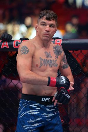 Apr 12, 2025; Miami, Florida, UNITED STATES; Darren Elkins (red gloves) fights against Julian Erosa (not pictured) during UFC 314 at Kaseya Center. Mandatory Credit: Sam Navarro-Imagn Images