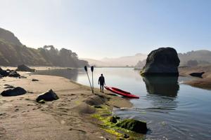River guide Keith Chandler prepares to kayak at the Russian River estuary at Jenner on the Sonoma County coast.