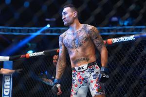 Apr 13, 2024; Las Vegas, Nevada, USA; Max Holloway (blue gloves) reacts after defeating Justin Gaethje (not pictured) during UFC 300 at T-Mobile Arena. Mandatory Credit: Mark J. Rebilas-USA TODAY Sports