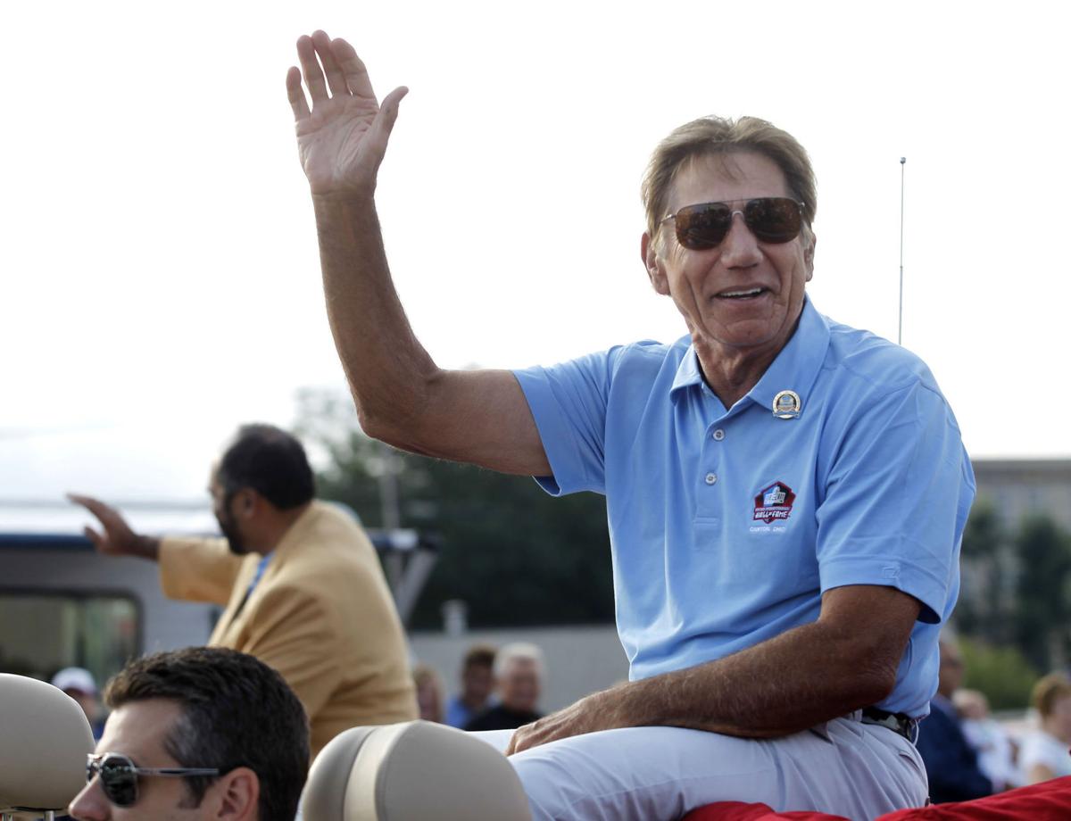 Former New York Jets quarterback Joe Namath rides in the Pro Football Hall of Fame Enshrinement Festival Grand Parade in downtown Canton, Ohio, on Saturday, Aug. 3, 2013.