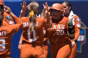 Texas Longhorns utility Katie Stewart (20) celebrates after hitting a home run in the fifth inning of a Women's College World Series softball game between the University of Texas Longhorns and the Tennessee Lady Volunteers at Devon Park in Oklahoma C