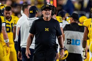 Michigan football coach Kyle Whittingham watches a replay during his team's game against Western Michigan at Michigan Stadium in