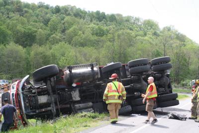 Asphalt truck rolls over on Solomon Run Road; driver not ...