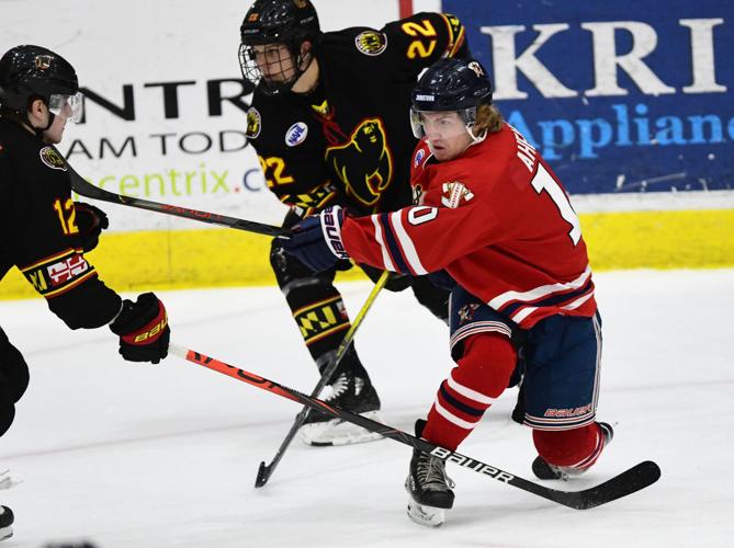 Johnstown Tomahawks' Caden Lewandowski, left, and Ryan Poorman, right, and Maryland  Black Bears' Brad McNeil, center, and Jack Brackett try to get possession  of the puck during a North American Hockey League