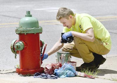 Cameron Bunn painting hydrants