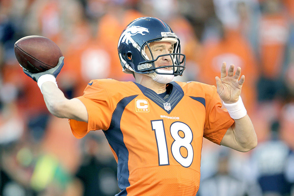 Quarterback John Elway raises his hands in victory after he is