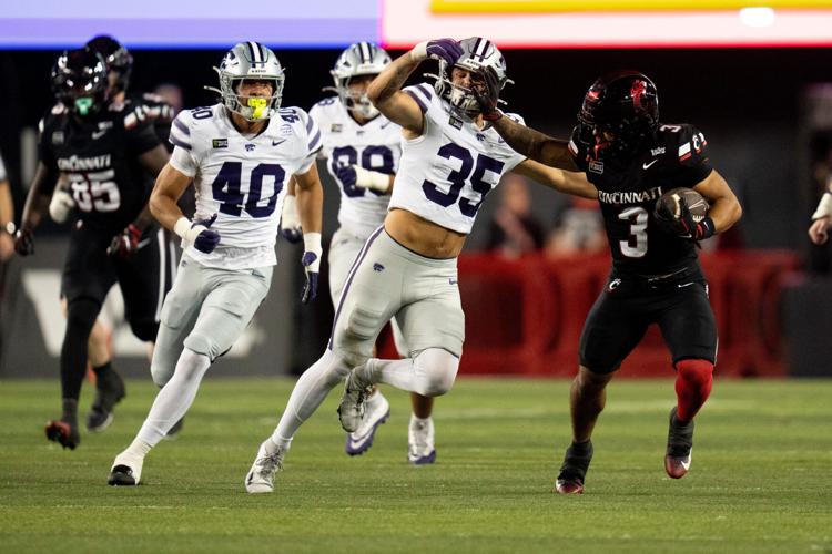 Cincinnati Bearcats running back Cole Tabb (3) stiff arms Kansas State Wildcats linebacker Gabe Powers (35) in the second