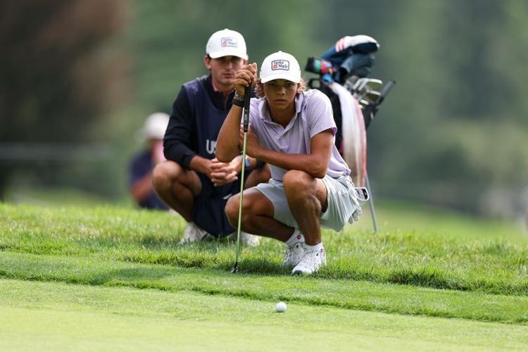 Charlie Woods reads his putt with his caddie on the 16th hole during the second round of stroke play of the 2026 U.S. Junior Amateur at Saucon Valley C.C. (Old Course) in Bethlehem, Pa. on Tuesday, July 21, 2026.