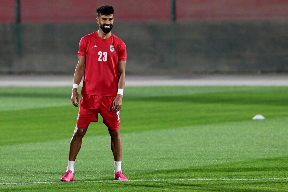 Iran's defender Ramin Rezaeian reacts as he takes part in a training session at the Al-Rayyan training facility in Doha on November 27, 2022, during the Qatar 2022 World Cup football tournament.