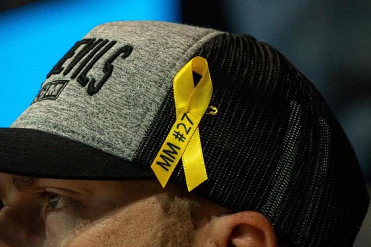 A yellow ribbon with "MM #27" written in black, a tribute to Matthew Mayich, given away to fans prior to Arizona State Hockey's Oct. 9, 2026, matchup against Holy Cross at Mullet Arena.