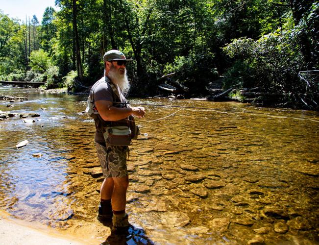 Pisgah Outdoors owner and operator Heath Cartee fly fishes in the South Mills River in the Turkey Pen area of Pisgah National Forest on Aug. 24, 2026. Cartee said sediment from road construction and logging could threaten fish habitat if protections under
