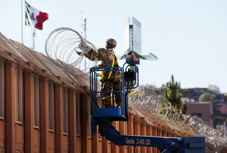 Troops install concertina wire at border fence