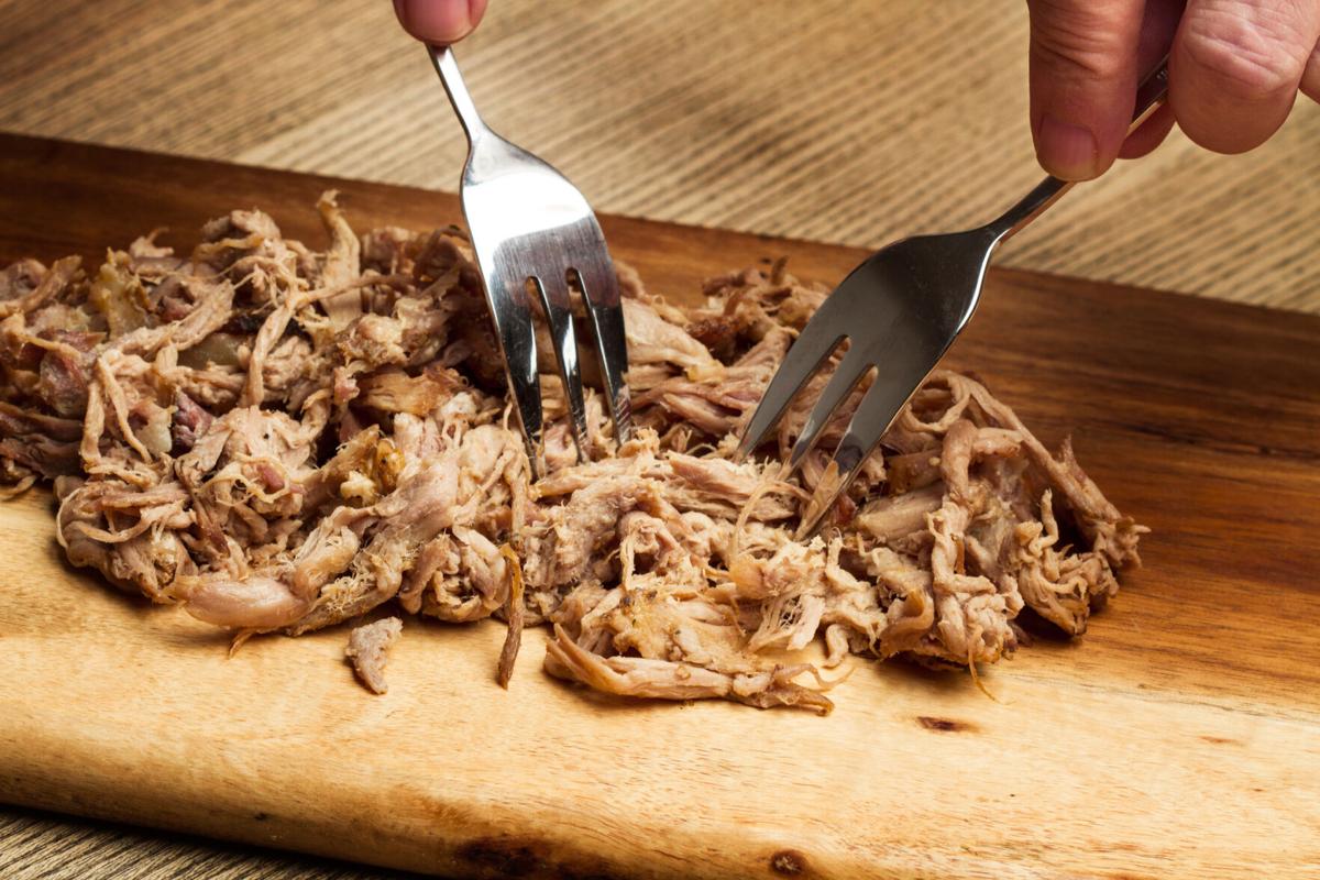 Man with two forks and pulled pork