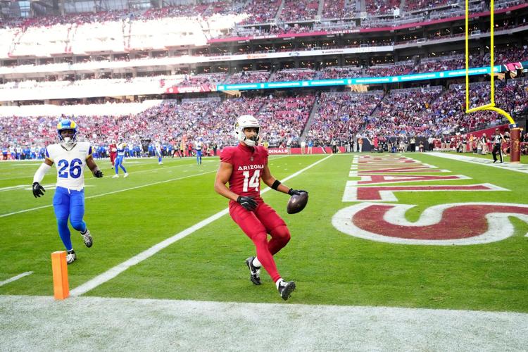 Arizona Cardinals wide receiver Michael Wilson (14) makes a touchdown catch against Los Angeles Rams safety Kamren Kinchens (26) in the first half at State Farm Stadium on Dec 7, 2025, in Glendale, Ariz.