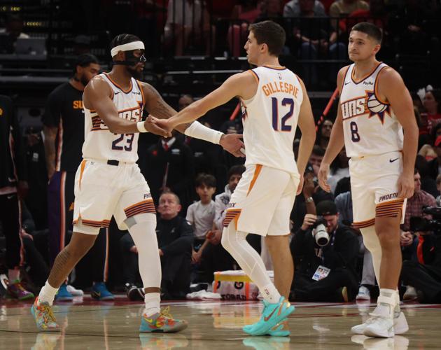 Phoenix Suns guard Jordan Goodwin (23) and Phoenix Suns guard Collin Gillespie (12) react to a Suns basket against the Houston Rockets in the second quarter at Toyota Center on Jan. 5, 2026.