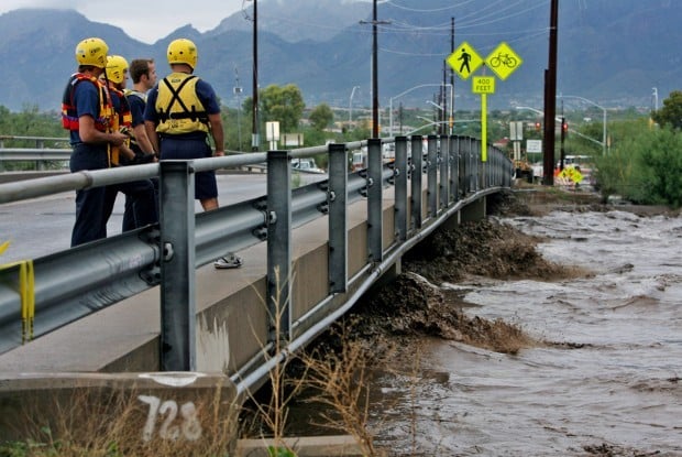 Flood waters flow under the North Dodge Blvd. bridge