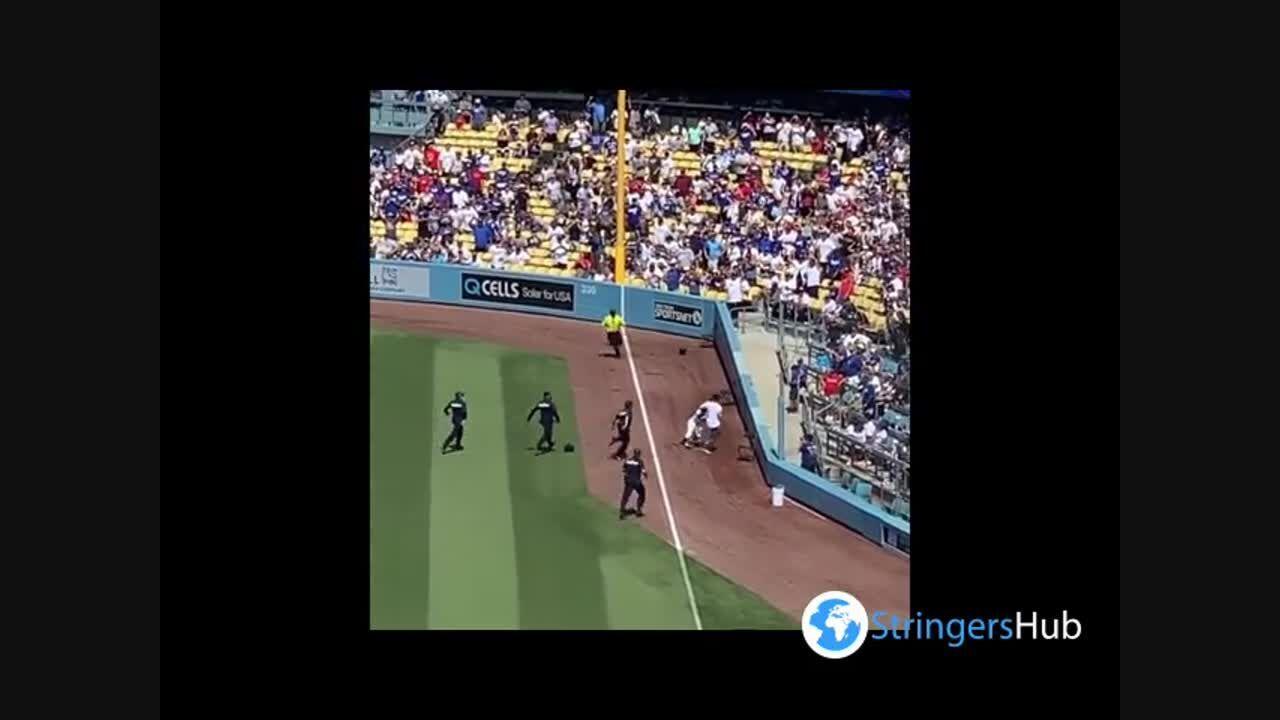 Fan Runs Onto Field at Dodger Stadium, Ball Girl Tosses Him Into