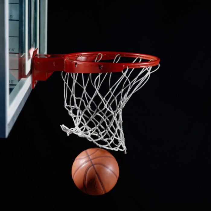 Basketball in hoop stock image