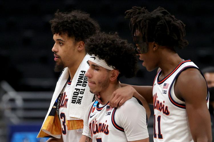 Jacob Grandison #3, Andre Curbelo #5 and Ayo Dosunmu #11 of the Illinois Fighting Illini react after being defeated by the Loyola Chicago Ramblers in the second round game of the 2021 NCAA Men's Basketball Tournament at Bankers Life Fieldhouse on March 21, 2021, in Indianapolis.