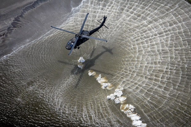 Sandbags, diverted river flow part of efforts to hold back oil   