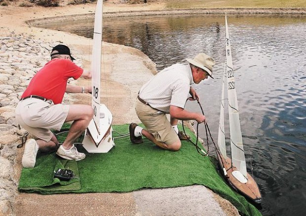 Sailboats race across a pond  