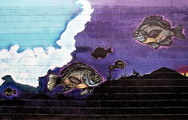 Downtown wall that stirred furor redone with less-strident imagery  