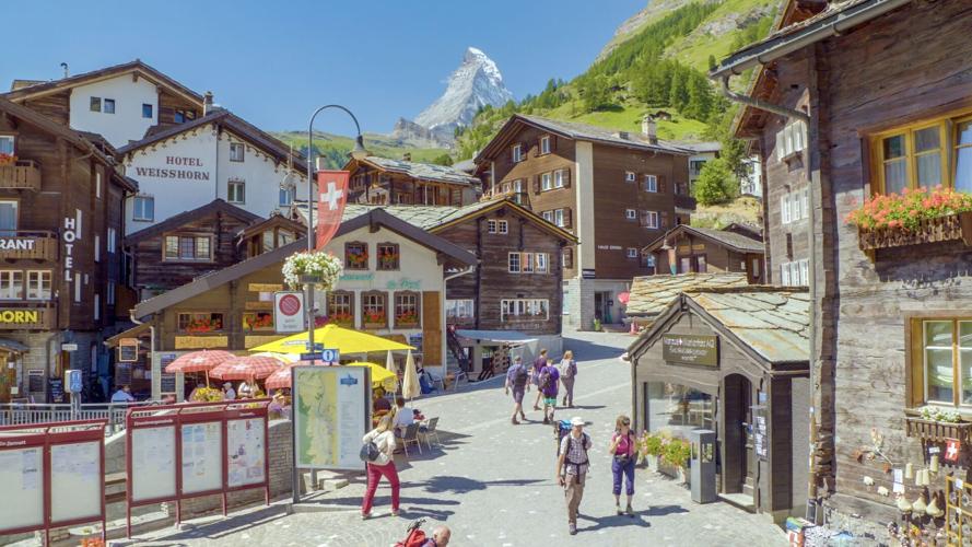 Zermatt is often socked in by clouds— but if you’ re lucky to be there on a clear day, you’ ll see the Matterhorn peeking out above the chalet rooftops and surrounding hills.