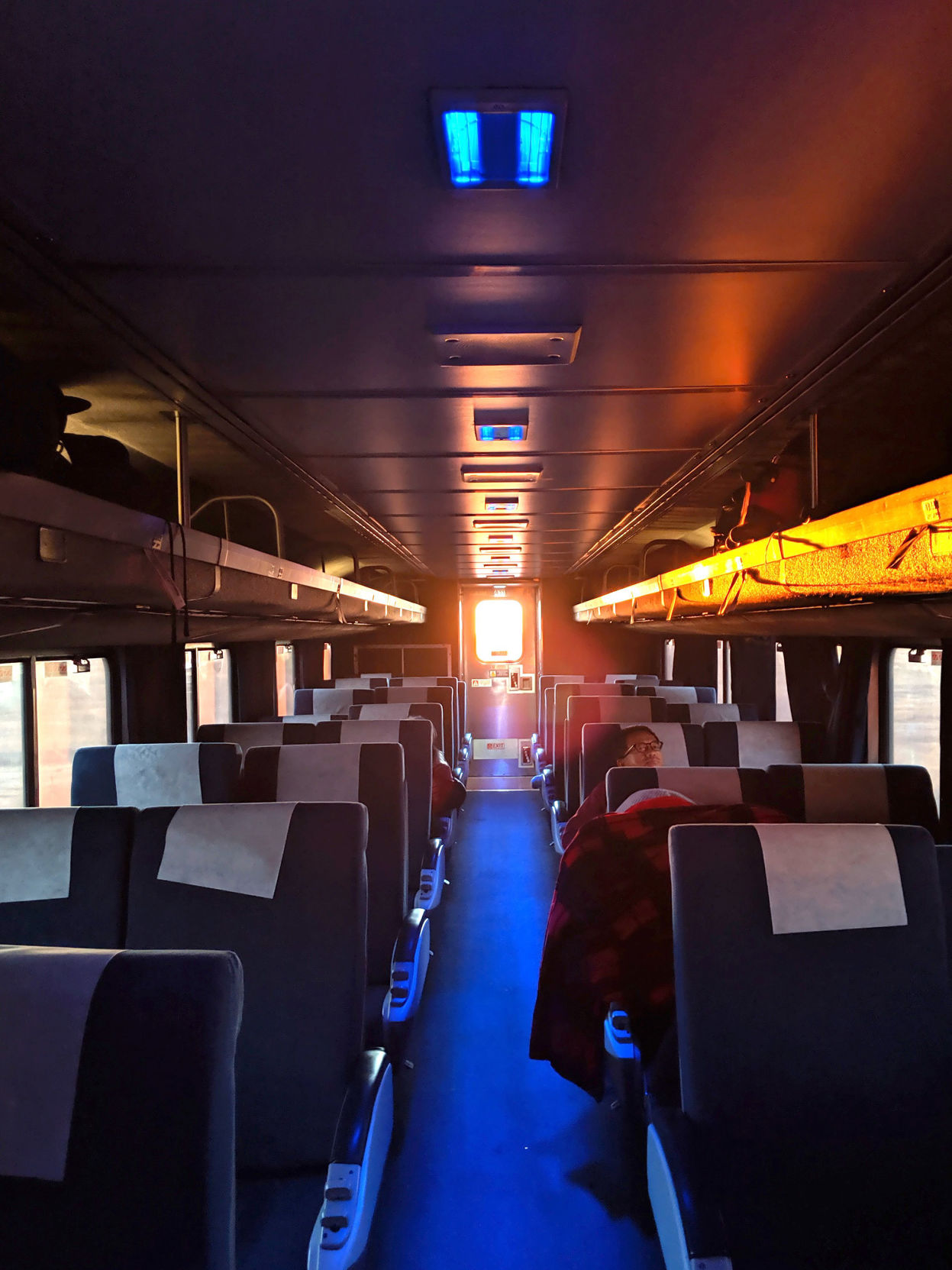 Light bursts through the back window of the Southwest Chief's last train car while traveling due west across Kansas at sunrise.