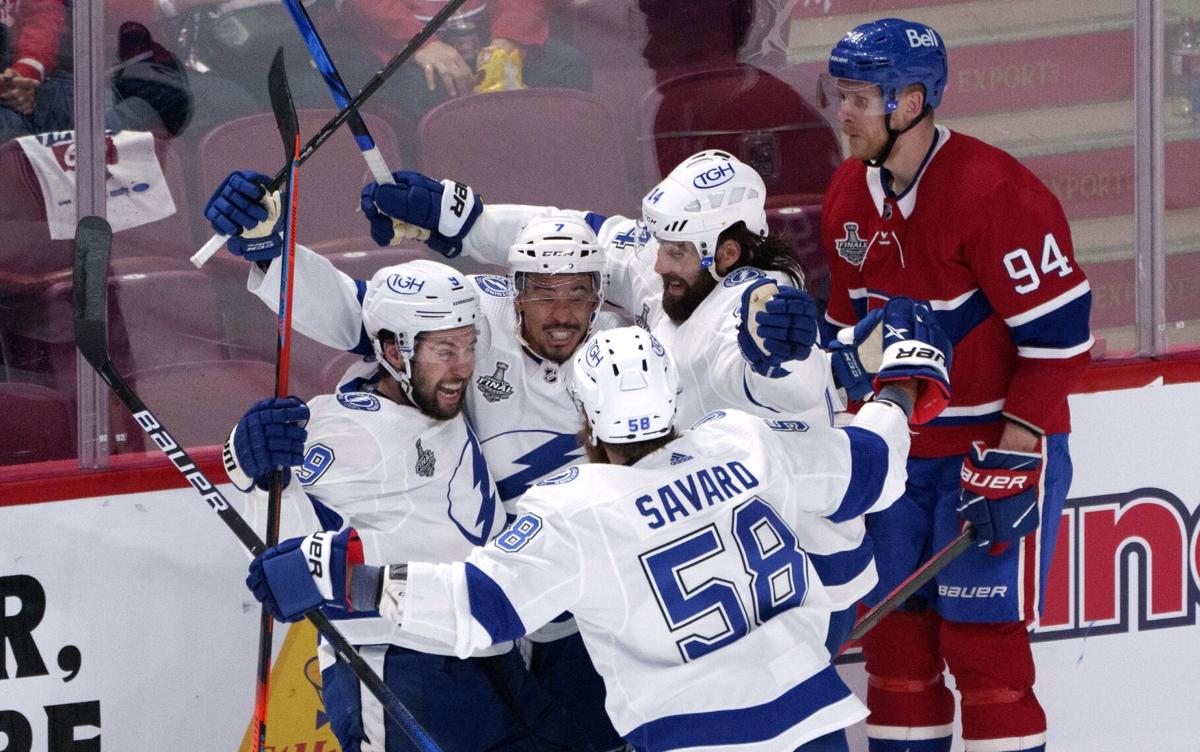 Lightning defenseman Erik Cernak, front, celebrates his goal along with  right wing Nikita Kucherov after Cernak beat Canadiens goaltender Carey  Price to score in Game 1 of the Stanley Cup final. (Photo