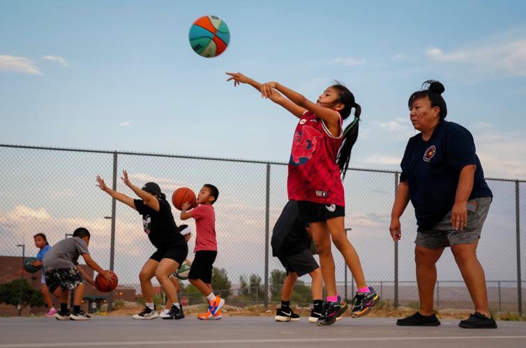 The Rez Hoops youth team practices on the courts outside Tuba City High School in Tuba City, Arizona, on Aug. 11, 2026.