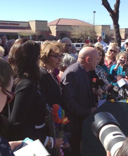 Giffords at Tucson shooting site: Expand gun-buyer background checks
