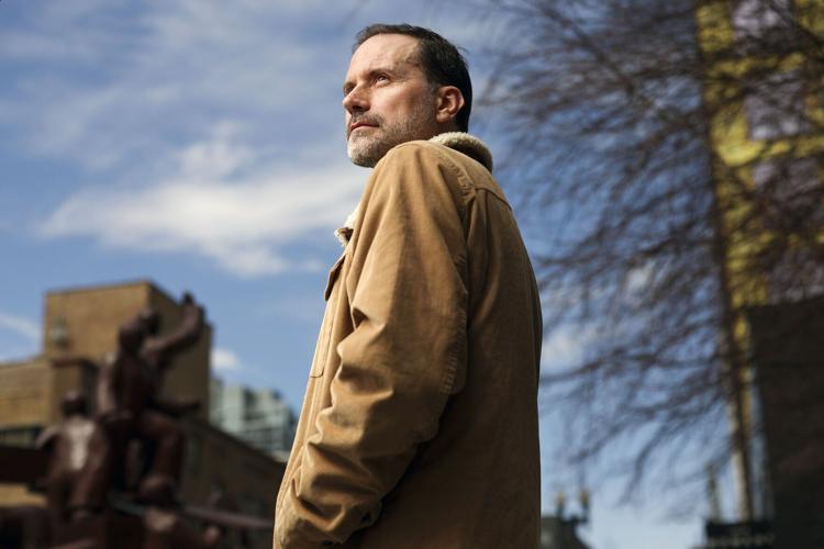Zayd Ayers Dohrn, a playwright and Northwestern professor, stands near the Haymarket Memorial in the West Loop on April 9, 2026. Dohrn, the son of Bill Ayers and Bernardine Dorhn, the longtime Hyde Parkers and leaders of the militant activist group The Weather Underground, used to take him to the Haymarket Memorial to illustrate the history of activism.