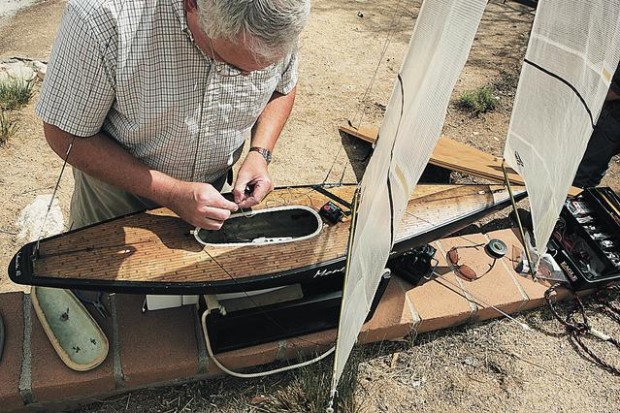 Sailboats race across a pond  