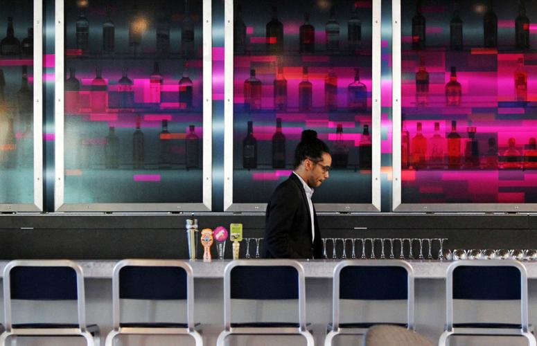 Phil Frazier walks the WXYZ bar area inside the Aloft hotel.
