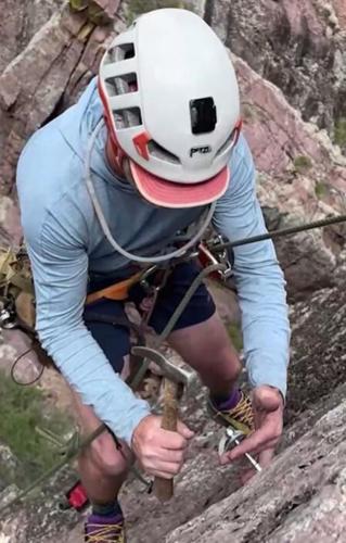 Climber Aaron Collins installs anchors along a new rock climbing route in Arizona. Collins is one of a few dozen volunteers working to expand Arizona's rock climbing opportunities.