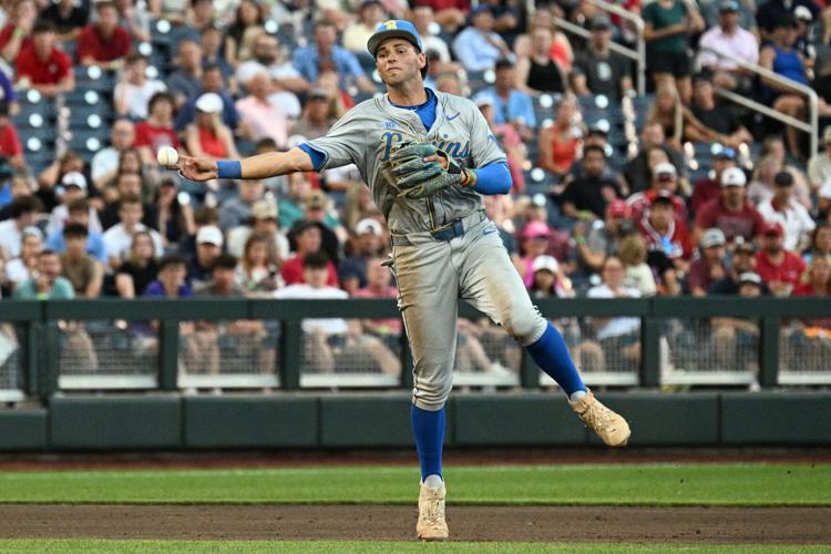 Jun 17, 2025; Omaha, Neb, USA; UCLA Bruins shortstop Roch Cholowsky (1) throws to first base against the Arkansas Razorbacks during the third inning at Charles Schwab Field. Mandatory Credit: Steven Branscombe-Imagn Images