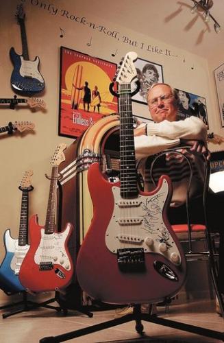 Music fan keeps signatures of rock stars on everything from posters to prized guitars  