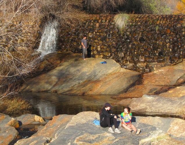 Hikers beside a pool