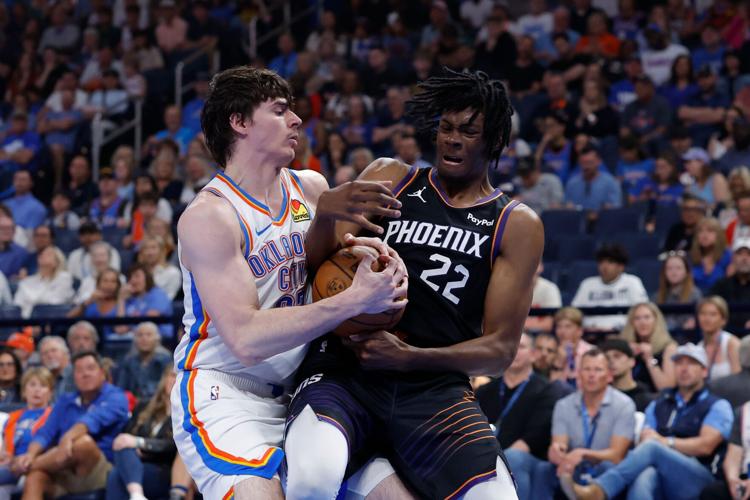 Apr 12, 2026; Oklahoma City, Oklahoma, USA; Oklahoma City Thunder forward Brooks Barnhizer (23) and Phoenix Suns forward CJ Huntley (22) fight for a loose ball during the first quarter at Paycom Center. Mandatory Credit: Alonzo Adams-Imagn Images