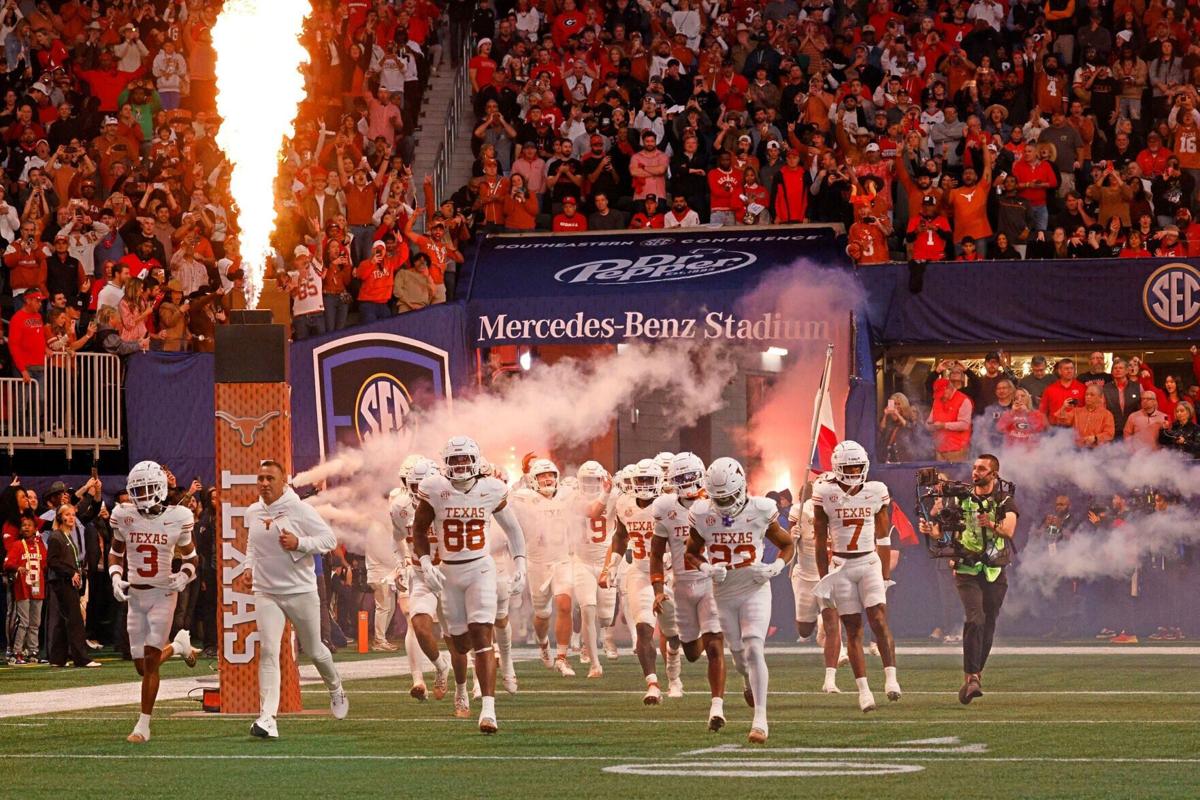 Texas head coach Steve Sarkisian and his players run out to the field before the Southeastern Conference championship NCAA college football game against Georgia at Mercedes-Benz Stadium, Saturday, Dec. 7, 2024 in Atlanta.