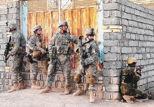 Soldiers hunker down against an enemy literally next door  