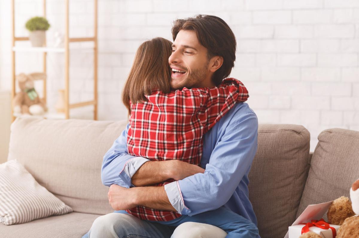 Emotional dad hugging daughter, thankful for greeting